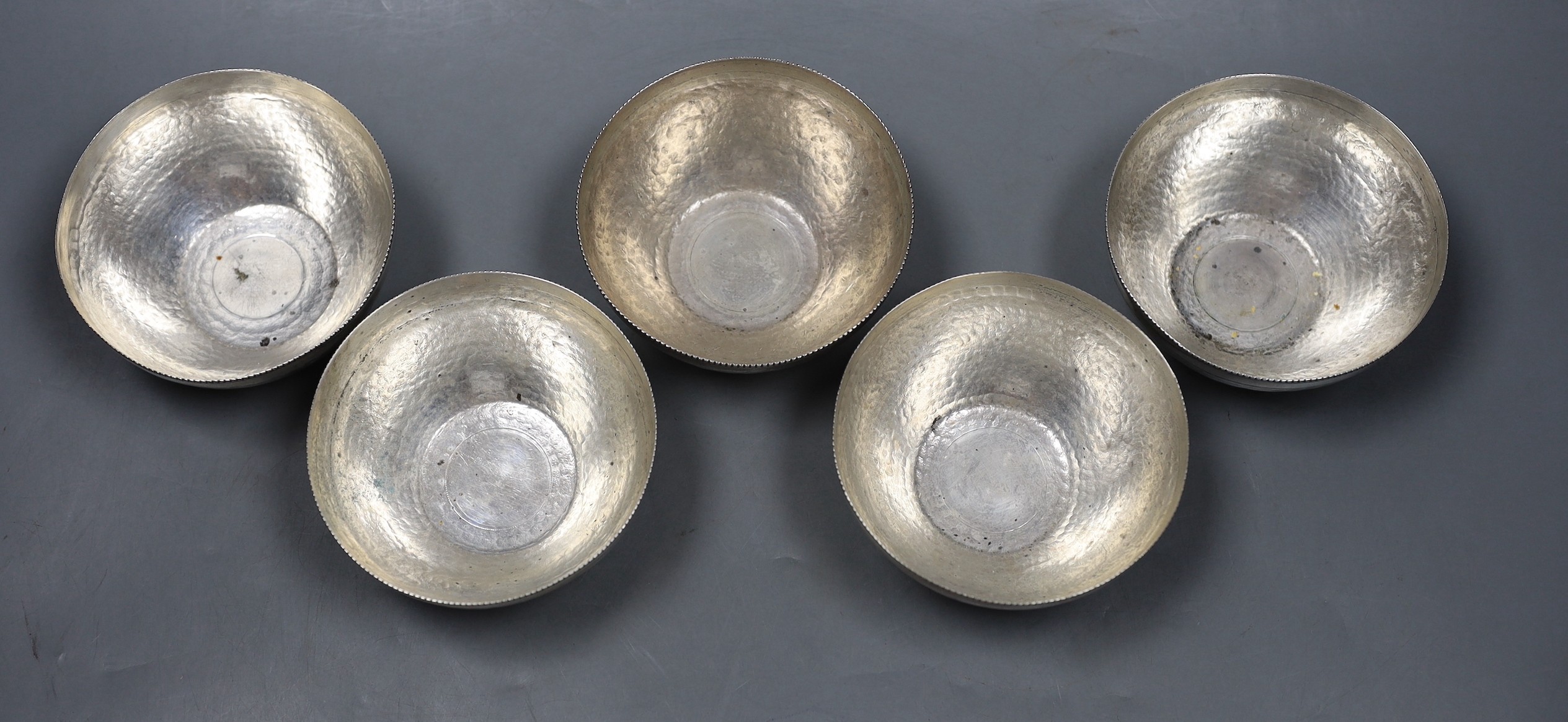 A set of five early to mid 20th century Egyptian planished white metal finger bowls, diameter 10.5cm, 22.5oz.